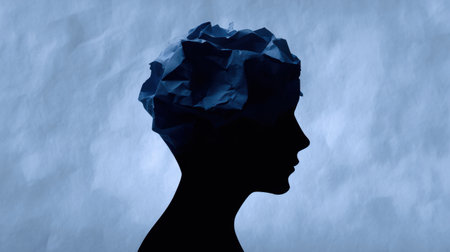 A person's head is made of paper. The paper is crumpled and torn, giving the impression of a person who is overwhelmed or stressed. Concept of chaos and disarrayの素材