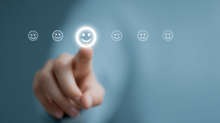 A person is pressing a button with a smiley face on it. Concept of positivity and happinessの素材