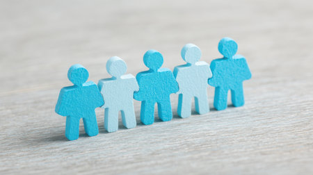 A group of people are standing in a row, with some of them being blue. Concept of unity and togetherness, as the people are all standing close to each otherの素材