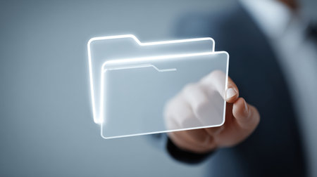 A man is holding a transparent folder in his hand. The folder is glowing and he is a digital file. Concept of modern technology and the importance of digital documents in today's worldの素材