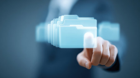 A person is pointing at a blue folder with a white label that says "Important". The folder is surrounded by other folders, and the person is pressing a button to highlight itの素材