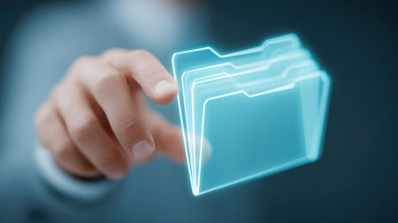A person is holding a folder in their hand, with the folder appearing to be a computer file. The folder is blue and has a transparent backgroundの素材