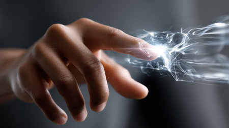 A hand is reaching out to touch a glowing object. Concept of wonder and curiosity, as if the hand is trying to grasp something beyond its reach. The glowing object could represent a new discoveryの素材