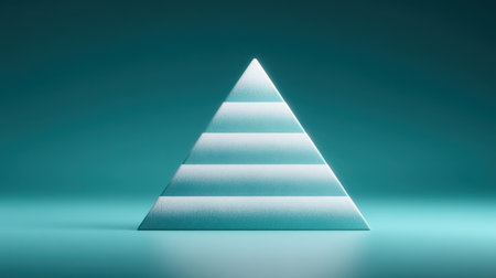 A blue and white pyramid with snow on it. The pyramid is made of ice and is on a blue surfaceの素材