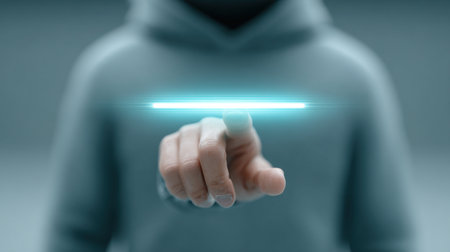 A person is pointing at a glowing line on a screen. Concept of technology and innovation, as the person's hand is hovering over the glowing line, suggesting that they are interacting with itの素材
