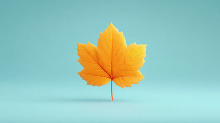 A leaf is shown on a blue background. The leaf is orange and has a shiny appearance. Concept of warmth and vibrancy, as the bright orange color of the leaf contrasts with the cool blue backgroundの素材