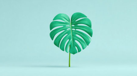 A large green leaf with a heart shape is displayed on a blue background. The leaf is the main focus of the image, and its heart shape adds a unique and artistic touch to the compositionの素材