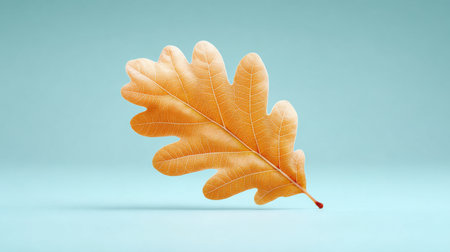 A leaf is shown on a blue background. The leaf is brown and has a shiny texture. Concept of natural beauty and tranquilityの素材