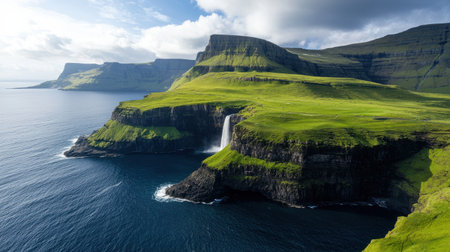 A beautiful landscape with a waterfall and a body of water. The water is blue and the sky is cloudyの素材