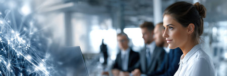 A woman is looking at a computer screen with a group of people in suits behind her. Concept of professionalism and collaboration, as the woman and her colleagues are working together on a projectの素材