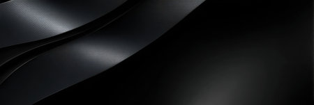 A black and white image of a black ribbon with a black background. The ribbon is long and has a shiny textureの素材