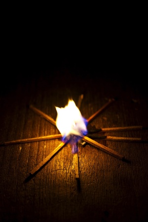 Burning match on a black backgroundの写真素材