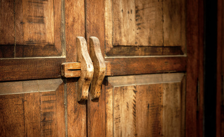 Old wood door with lock in Thailand