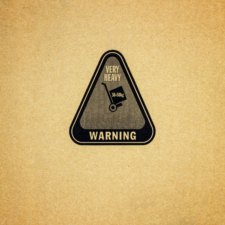 Fine image close-up of grunge black fragile symbol on cardboardの写真素材