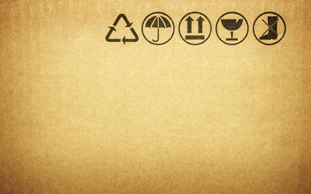Fine image close-up of grunge black fragile symbol on cardboardの写真素材