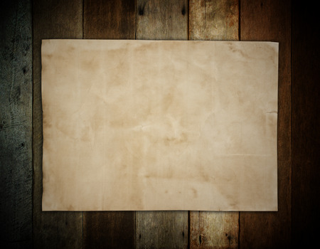 old brown paper on wooden wall background for textureの写真素材
