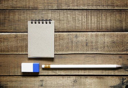 pencil and notepaper on wood, stationery office equipment  on wooden background.