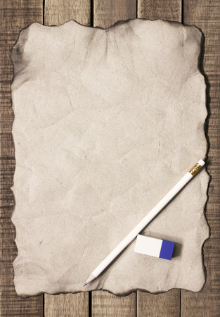 paper and pencil on wooden background.の写真素材