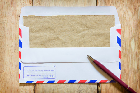 Notepaper and mail on wooden background. Top view. Copy space.の写真素材