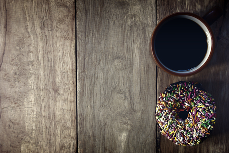 Black coffee and Donuts on wooden background, Coffee break, Free space for text, Top view. の写真素材