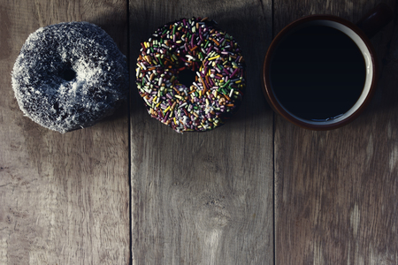 Black coffee and Donuts on wooden background, Coffee break, Free space for text, Top view. の写真素材