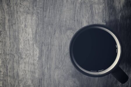 Black coffee on wooden table background. Top view. Free space for text.の写真素材