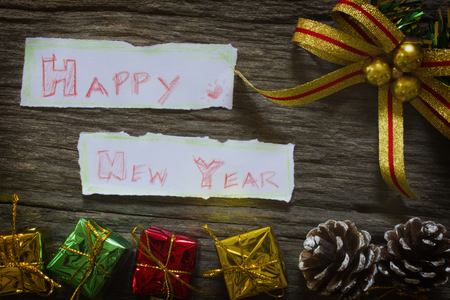 Happy new year for background. Christmas presents in gold boxes and  gift box on wooden tableの写真素材