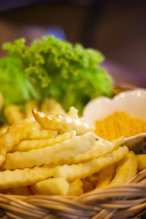 Tasty french fries and ketchup on wooden table backgroundの写真素材