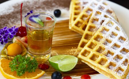 Homemade waffles with berries in plate on table at cafe.の写真素材