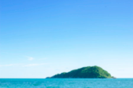 Island in the middle of the sea under the blue sky, blurred image concept.の写真素材