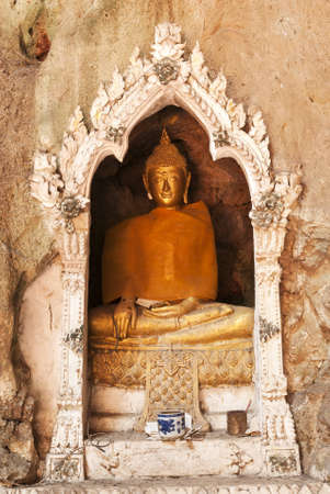 Buddha on stone babkground in cave of Thailandの写真素材