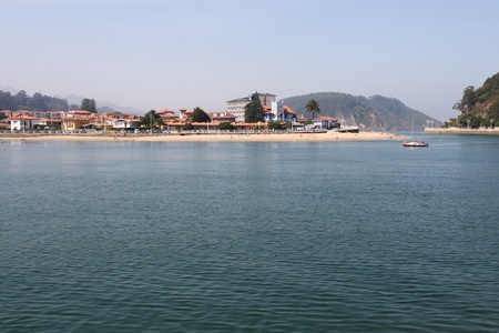 Beach on the estuary of the town of Ribadesella where it joins the River Sella and overlooking the sea and boat ride  Asturias  Spainの写真素材