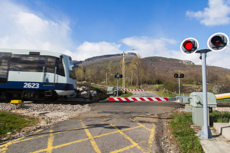 Traffic signs and barriers Level Crossing Road  Crossing via rail and road with street lamps in mountain area  のeditorial素材