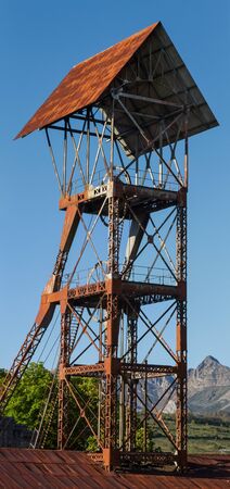 headframe   tower elevation   of old hangar mine shaft and closed between trees  and vegetation...