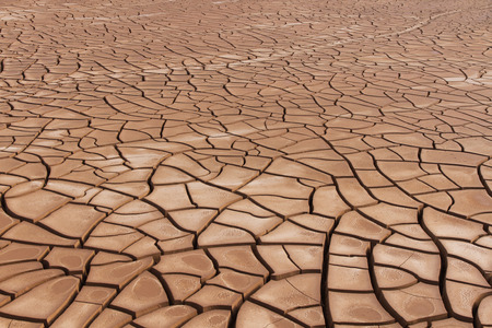 Basin sludge tank gravel with clay soil cracked by the absence of waterの写真素材