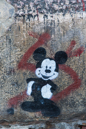 Leon, SPAIN - December 15, 2013: Mickey Mouse smiling Graffiti on a wall street