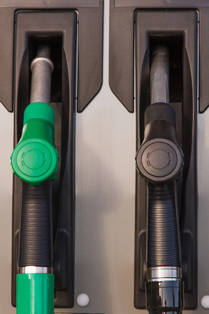Two jet nozzles or hoses with tap for dispensing fuel at a gas stationの写真素材