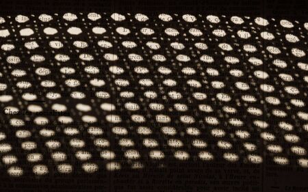 Old Newspaper texts in French views Through the shadow of a grid like a lattice