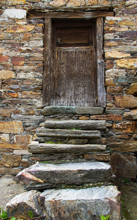 Stairs to the front door of a traditional rustic house built with stone slabsの写真素材