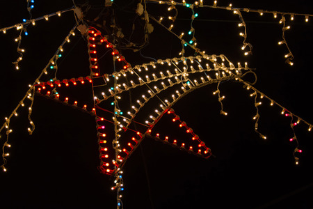 Christmas night illumination with star of Bethlehem illuminated by small light bulbs