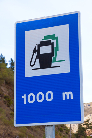 Informative traffic sign on the road that announces Gas station for fuel refueling of cars at 1 kmの写真素材