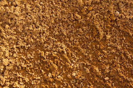 Detail of natural clay soil with rough texture partly moist and partly dry
