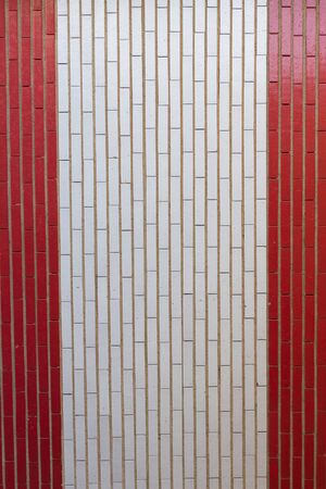 Brick Wall Access to garages painted in Red and White Bands