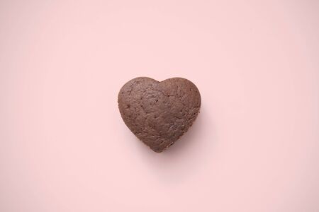 Chocolate Valentine Cake on pink background (heart shape)の写真素材