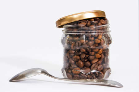 one can of roasted coffee beans a spoonful of brown sugarの写真素材