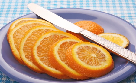 steel table knife and sliced   orange on the plate are blue の写真素材