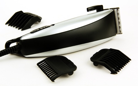 electric hair clipper with accessories for work, a photo on a light background 