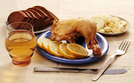 lunch of chicken with ingredients and a glass of white wine の写真素材