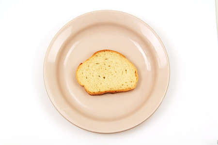 cut off a slice of white bread on the porcelain plate pink, photo on white background 