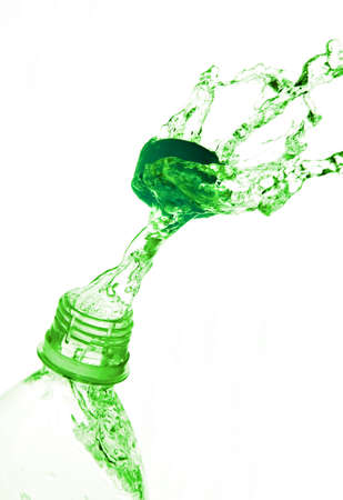 a jet of water from a bottle, beating in the discarded cover photo on the white background の写真素材